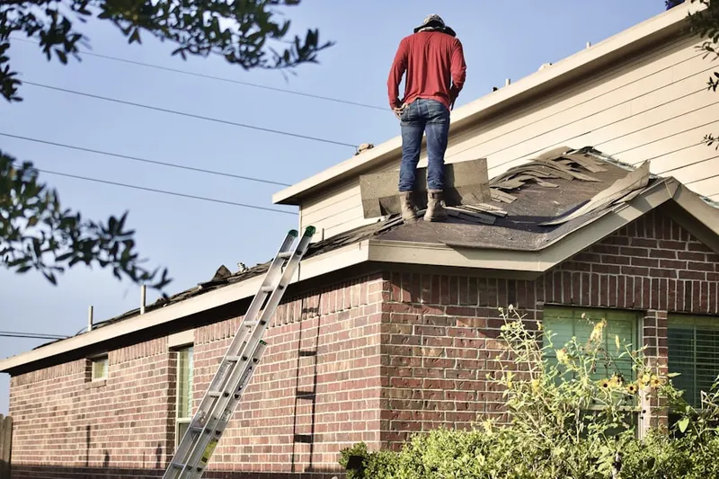 Professional roofer working on a residential roof in Harmon Haven